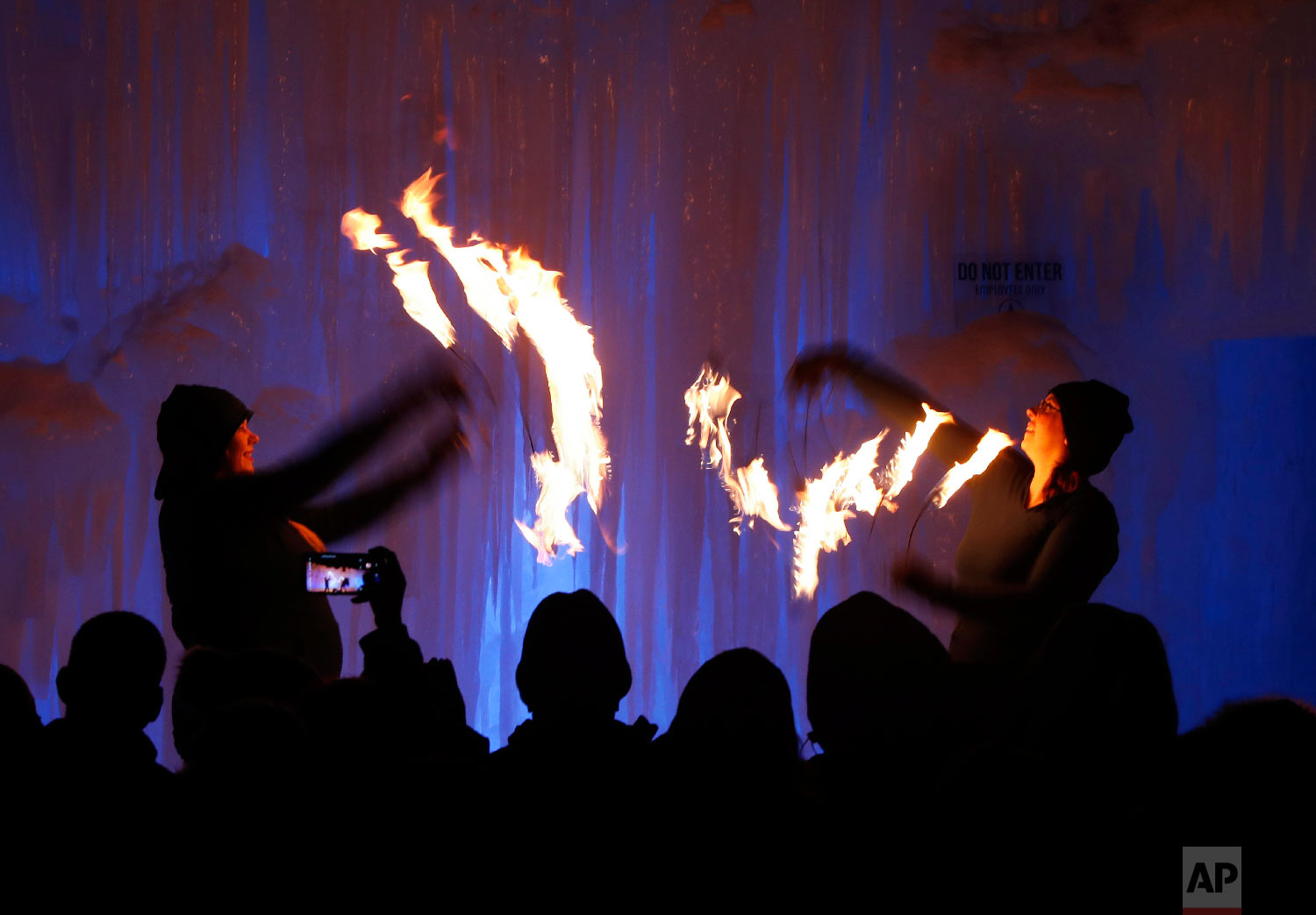 Fire dancers perform at Ice Castles, in North Woodstock, N.H., on Jan. 25, 2019. (AP Photo/Robert F. Bukaty)