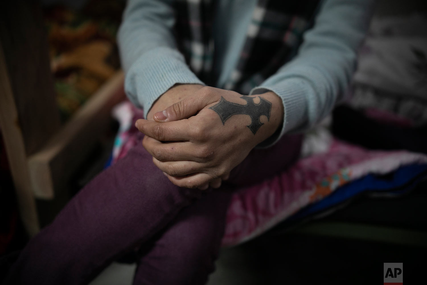  Xiomara Henriquez Ayala, 13, from El Salvador, sits on her sister Milagro's bed as they talk about their day, in a shelter for migrants on the outskirts of Tijuana, Mexico, Feb. 4, 2019. (AP Photo/Emilio Espejel) 
