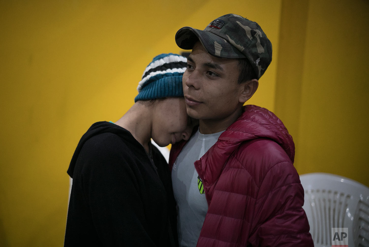  Central American teen migrants, Milagro de Jesus Henriquez Ayala, 15, and Josue Mejia Lucero, 17, embrace at the end of a Christian religious service in the Agape World Mission shelter in Tijuana, Mexico, Feb. 8, 2019. (AP Photo/Emilio Espejel) 