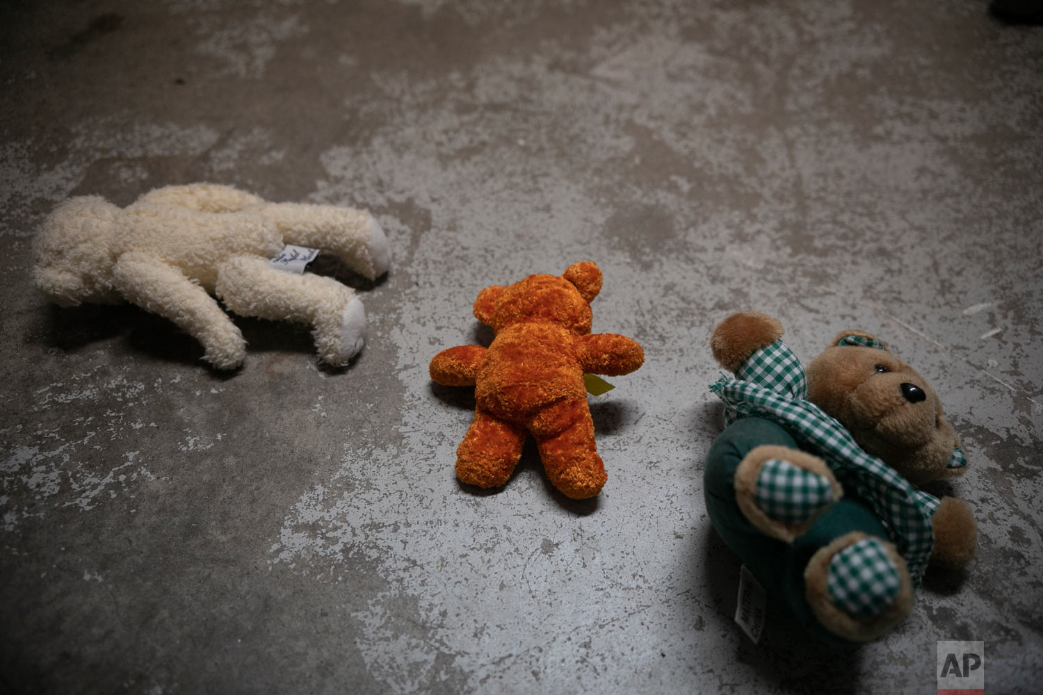  Teddy bears lie on the floor of the dormitory where Honduran migrant Josue Mejia Lucero's 3-year-old nephew Jefferson is staying with his mother, at Agape World Mission shelter in Tijuana, Mexico, Feb. 7, 2019 photo. (AP Photo/Emilio Espejel) 