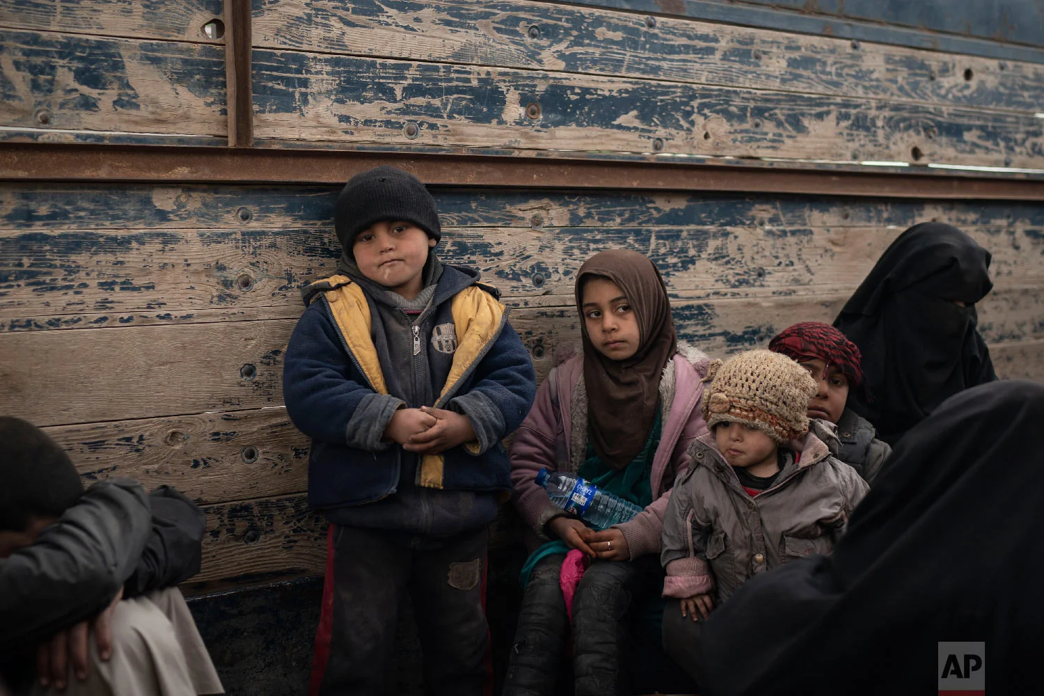  Women and children wait to be screened by U.S.-backed Syrian Democratic Forces (SDF) after being evacuated out of the last territory held by Islamic State militants, in the desert outside Baghouz, Syria, Feb. 27, 2019. (AP Photo/Felipe Dana) 