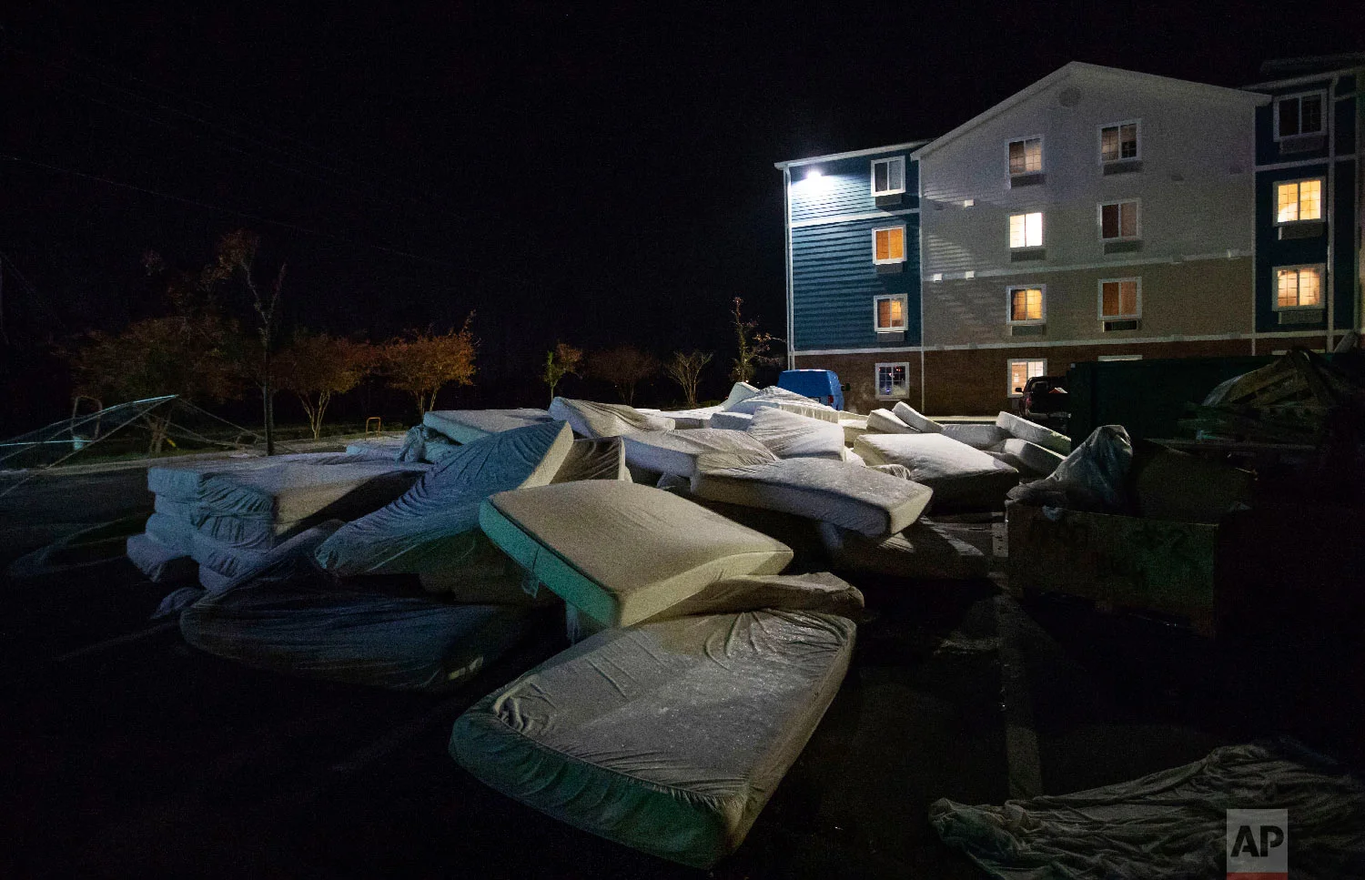 Mattresses are discarded from a damaged hotel from Hurricane Michael which is closed during renovation in Panama City, Fla, Thursday, Jan. 24, 2019. (AP Photo/David Goldman)