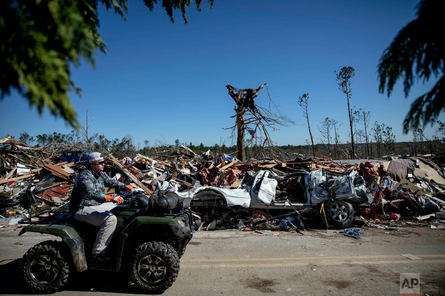 Debris sits on the side of a road in a neighborhood devastated by a tornado in Beauregard, Ala., March 5, 2019. (AP Photo/David Goldman)