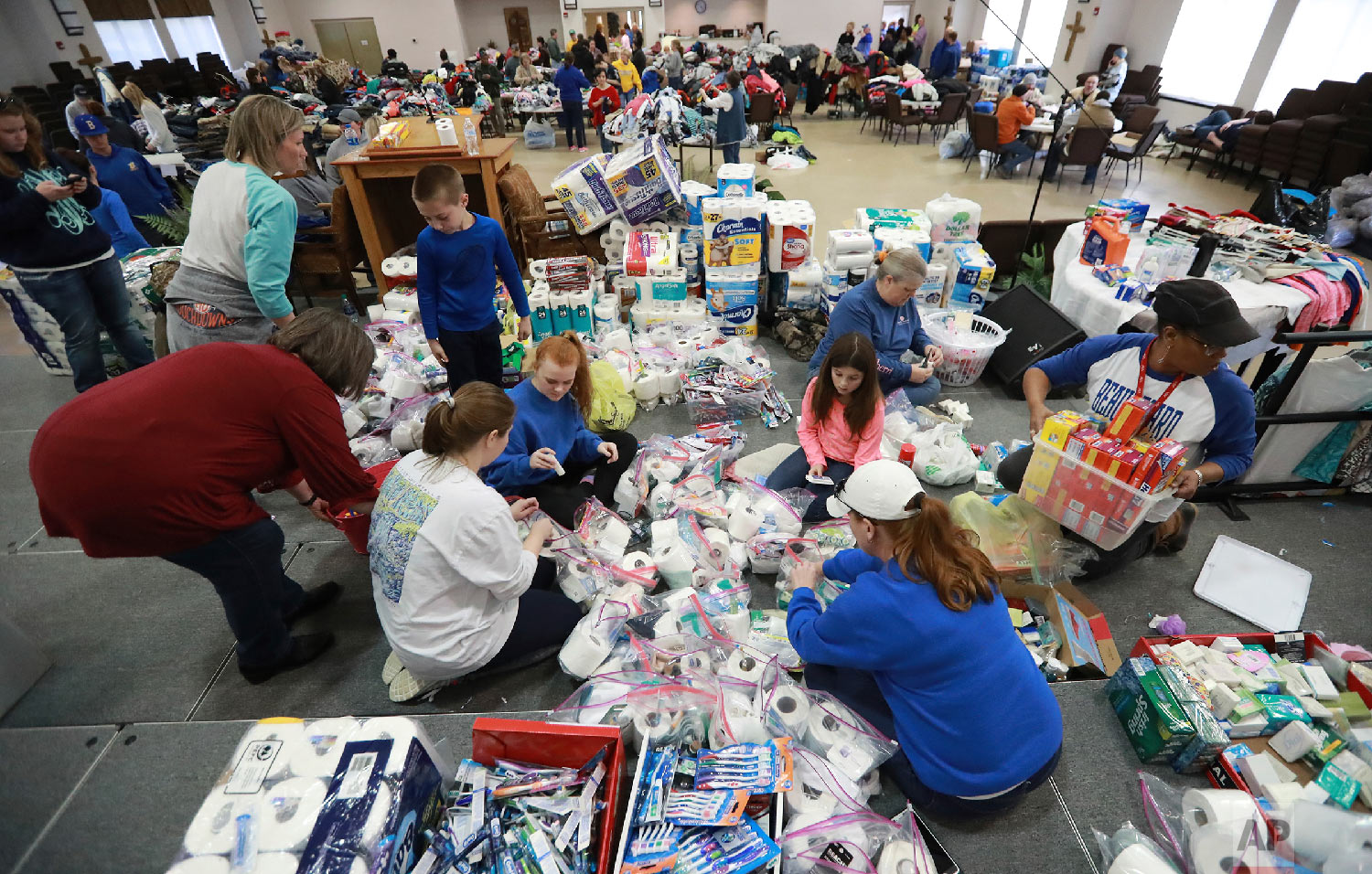 Dozens of volunteers help sort donated supplies pouring in from the community and local businesses at the Providence Baptist Church for those affected in nearby Beauregard a day after a tornado, March 4, 2019, in Opelika, Ala. (Curtis Compton/Atlanta Journal-Constitution via AP)