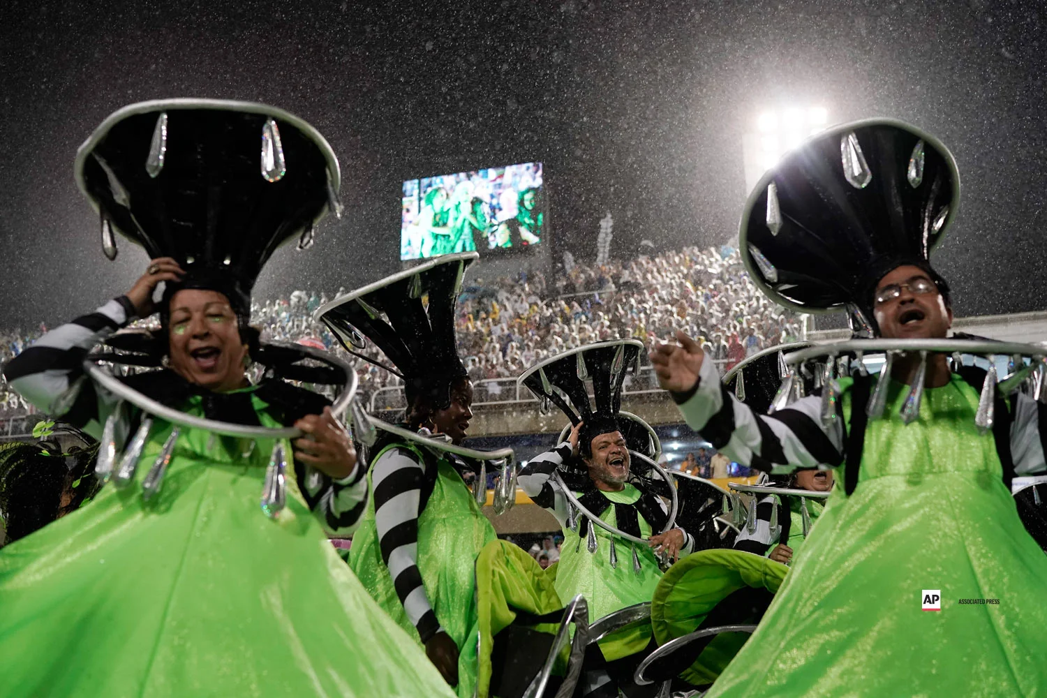 Performers from the Imperio Serrano samba school parade in the rain during Carnival celebrations at the Sambadrome in Rio de Janeiro, Brazil, Sunday, March 3, 2019. (AP Photo/Leo Correa)
