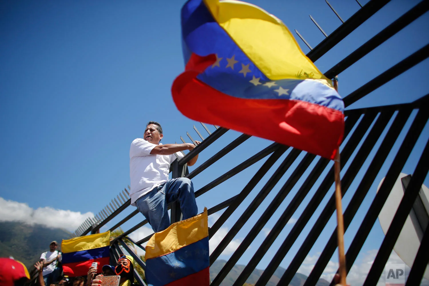  Opposition supporters converge in front of La Carlota military base urging soldiers to join their fight and allow the entry of U.S. humanitarian aid, in Caracas, Venezuela, Feb. 23, 2019. (AP Photo/Eduardo Verdugo) 