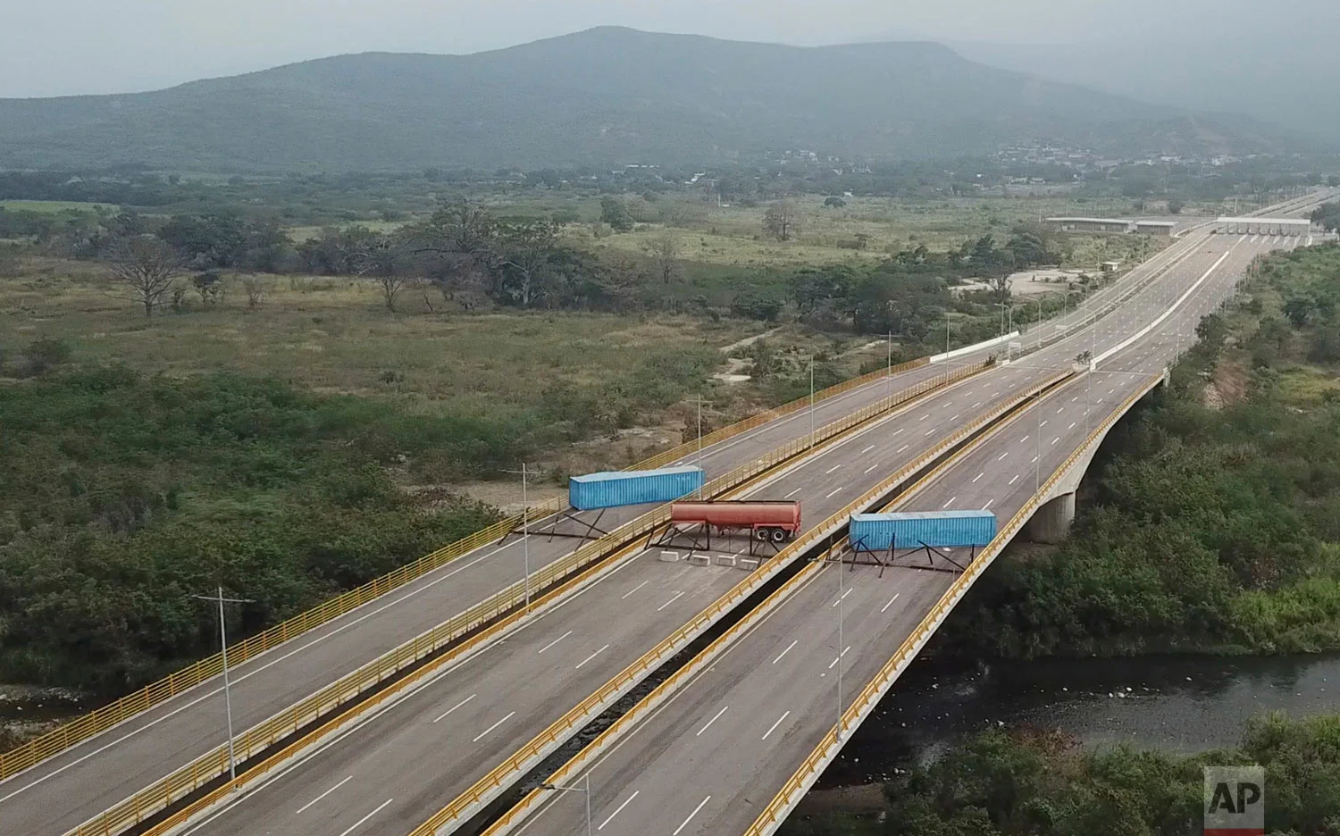  This image taken from video shows a fuel tanker, cargo trailers and makeshift fencing, blocking the Tienditas International Bridge in an attempt to stop U.S. humanitarian aid entering from Colombia into Venezuela, as seen from the outskirts of Cucut
