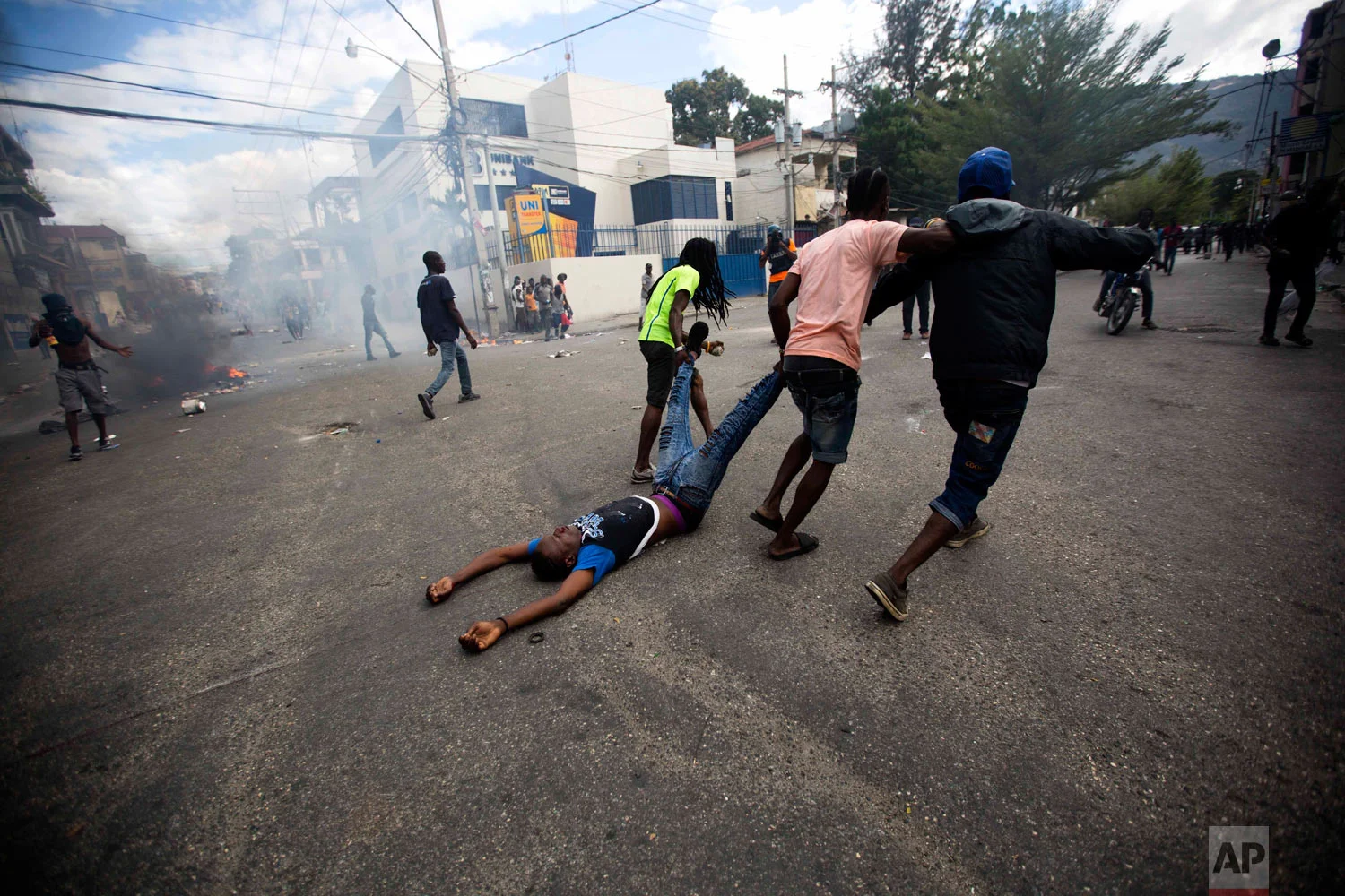  Demonstrators drag the body of an unidentified protester toward police, as a form of protest after police shot into the crowd killing the unidentified protester, during a demonstration demanding the resignation of Haitian President Jovenel Moise nea