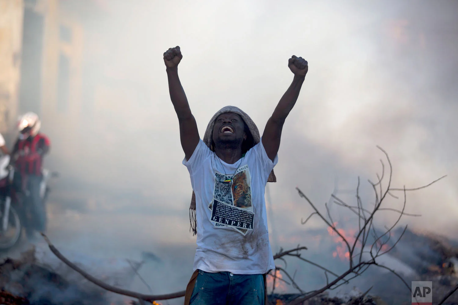 A demonstrator stands in the street chanting slogans against President Jovenel Moise during a protest to demand his resignation, in Port-au-Prince, Haiti, Feb. 9, 2019. (AP Photo/Dieu Nalio Chery) 