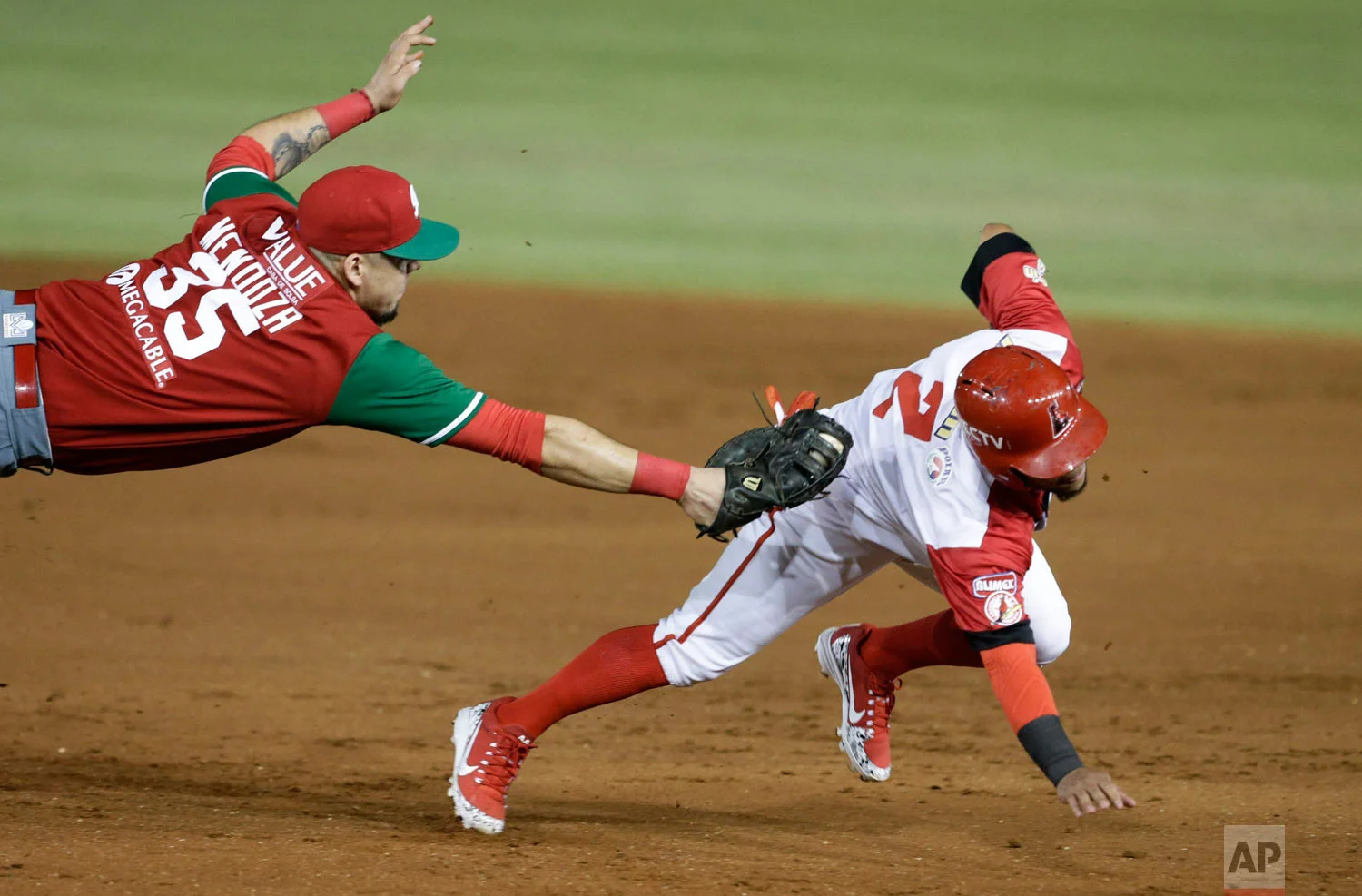 Victor Mendoza of Mexico's Los Charros de Jalisco tags out Alexi Amarista of Venezuela's Cardenales de Lara, on the opening day of the Caribbean Series baseball tournament at Rod Carew stadium in Panama City, Feb. 4, 2019. (AP Photo/Arnulfo Franco)