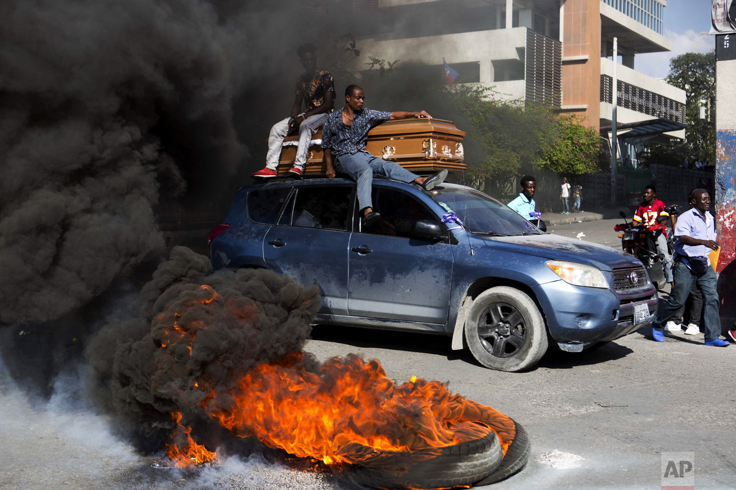  A car transports a coffin containing the body of one of the demonstrators who was killed during previous protests in Port-au-Prince, Haiti, Monday, March 4, 2019. People are protesting skyrocketing inflation and the government's failure to prosecute