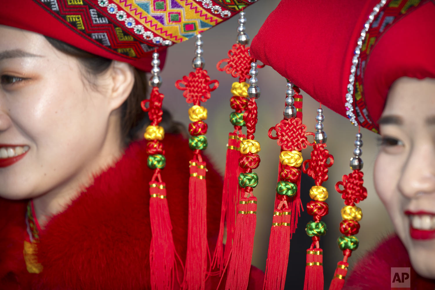  Decorations dangle from the hats of bus ushers in ethnic minority dress as they pose for a group photo during the opening session of China's National People's Congress (NPC) at the Great Hall of the People in Beijing on Tuesday, March 5, 2019. (AP P