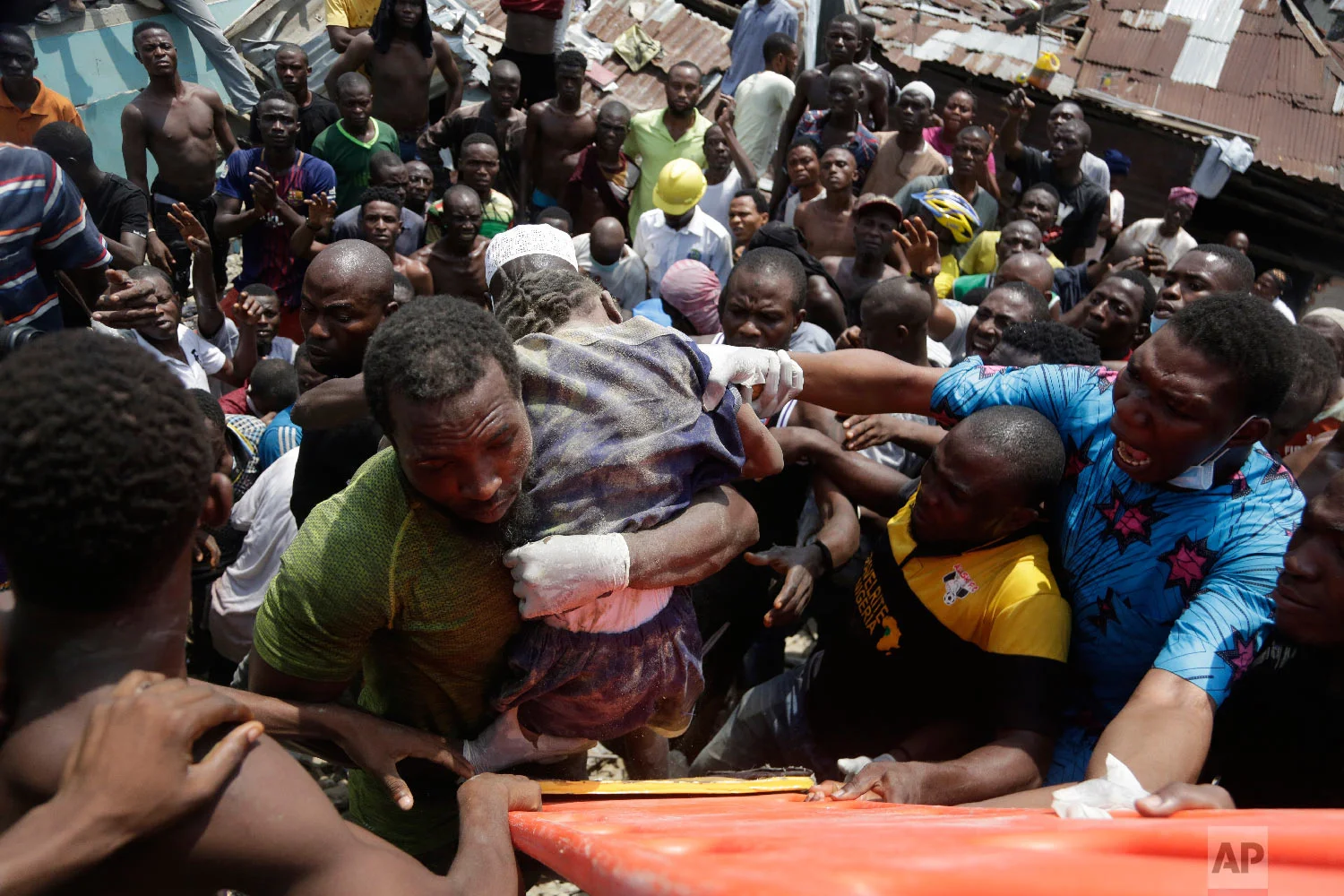 A child is rescued from the rubble of a collapsed building in Lagos, Nigeria, Wednesday, March 13, 2019. (AP Photo/Sunday Alamba)