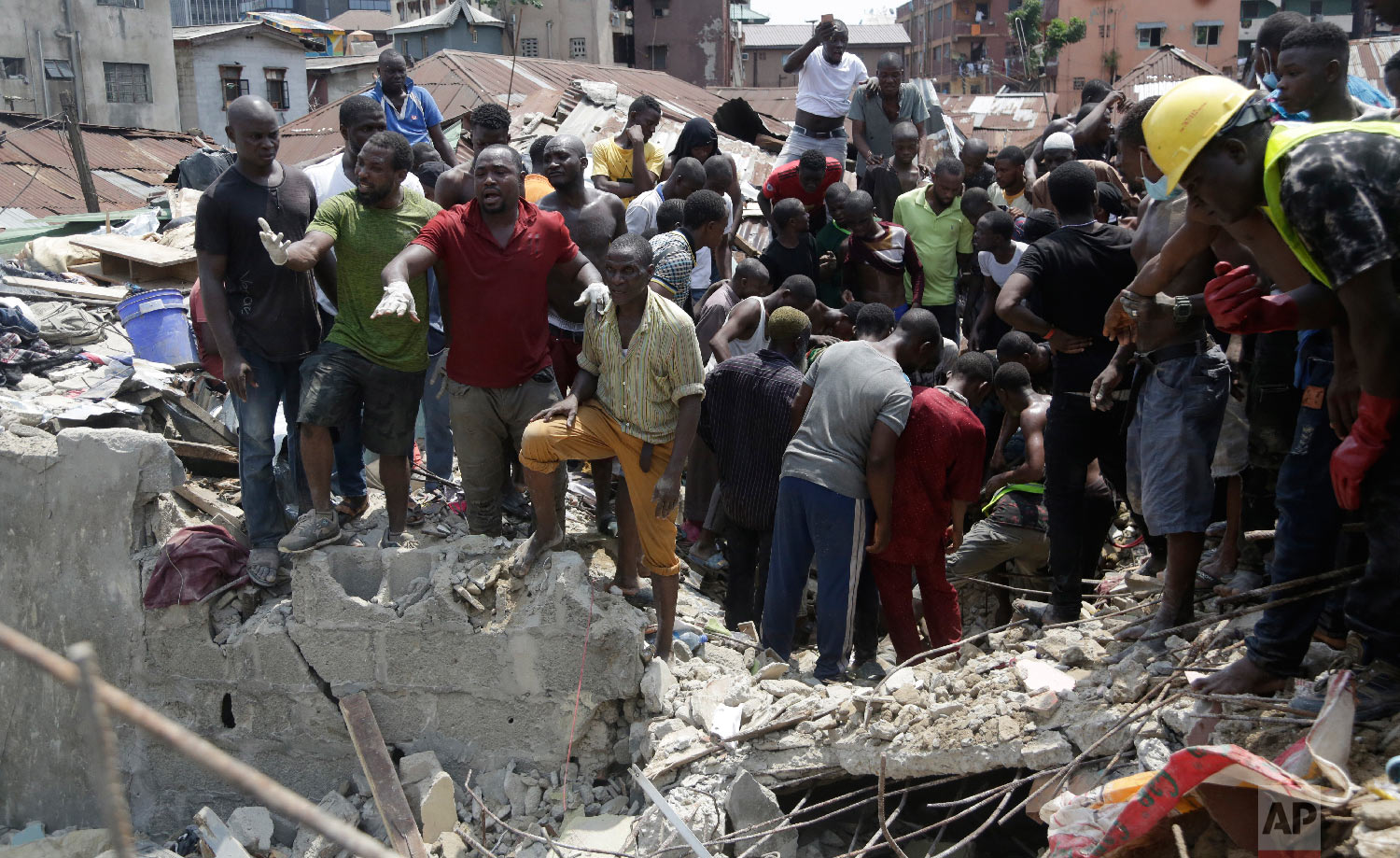 Emergency services attend the scene after a school building collapsed in Lagos, Nigeria, Wednesday, March 13, 2019. (AP Photo/Sunday Alamba)