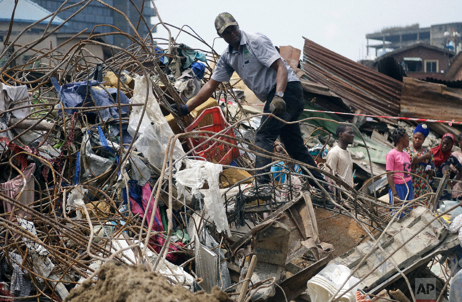 Government officials from Standard Organisation of Nigeria examine materials used in constructing the building that collapsed in Lagos, Nigeria, Thursday, March 14, 2019. (AP Photo/Sunday Alamba)