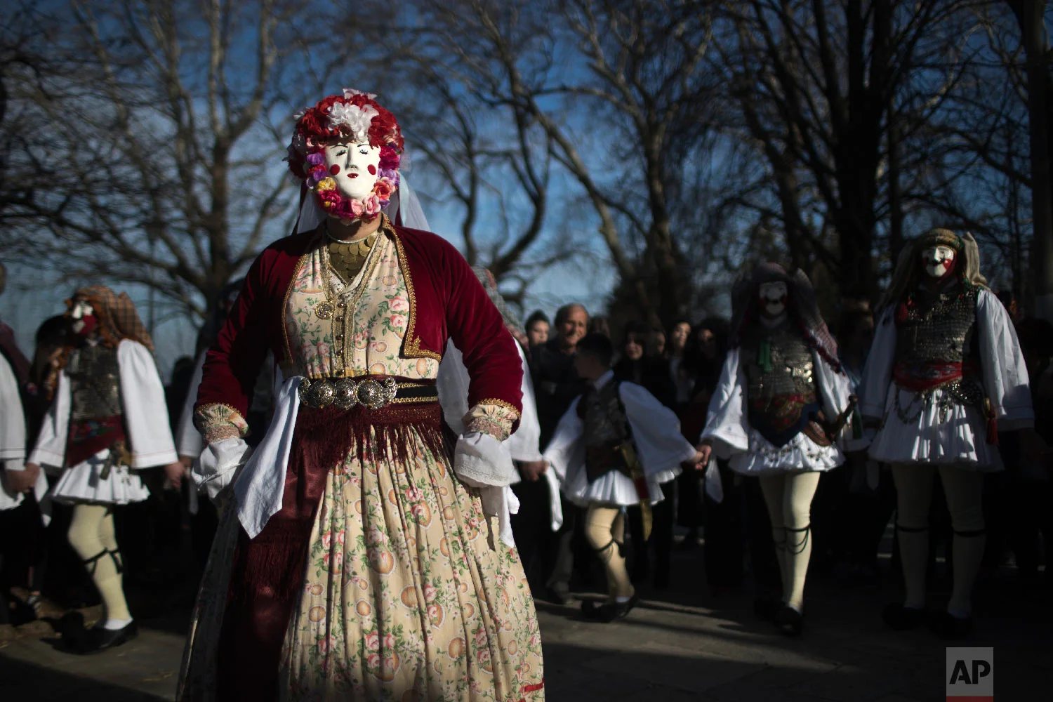 Dancers with masks and traditional costume perform in the Boules and Genitsaroi carnival parade in the town of Naousa, northern Greece on March 10, 2019. (AP Photo/Petros Giannakouris)