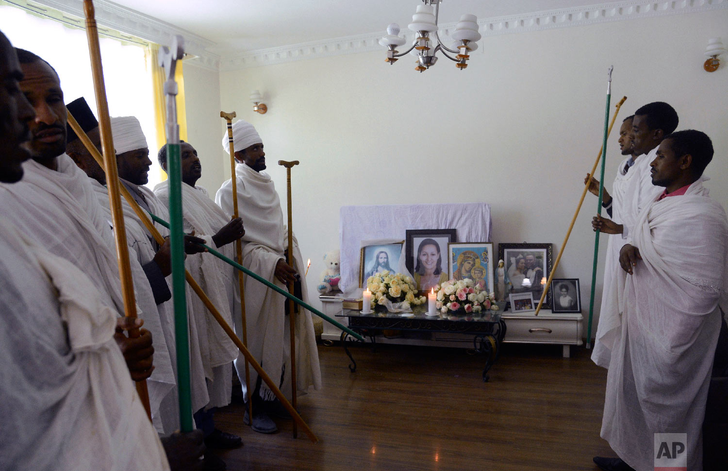 Ethiopian religious leaders pray at the house of crash victim air hostess Sara Gebremichael, 38, in Addis Ababa, Ethiopia, March 13, 2019. (AP Photo/Samuel Habtab)
