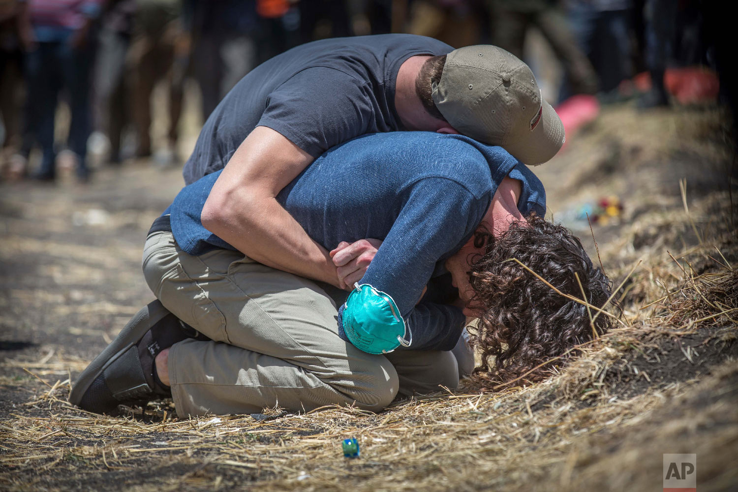 Relatives react at the scene where the Ethiopian Airlines Boeing 737 Max 8 crashed shortly after takeoff on Sunday near Bishoftu, Ethiopia, March 13, 2019. (AP Photo/Mulugeta Ayene)
