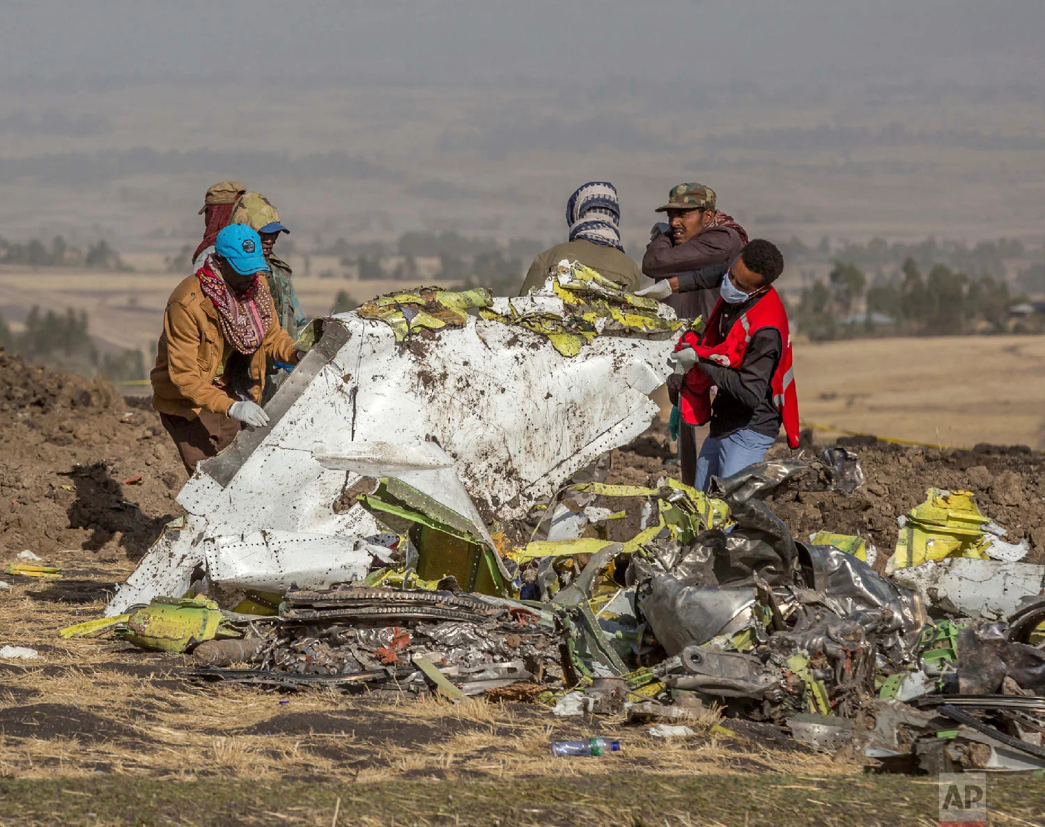 Rescuers work at the scene of an Ethiopian Airlines flight crash near Bishoftu, Ethiopia, March 11, 2019. (AP Photo/Mulugeta Ayene)