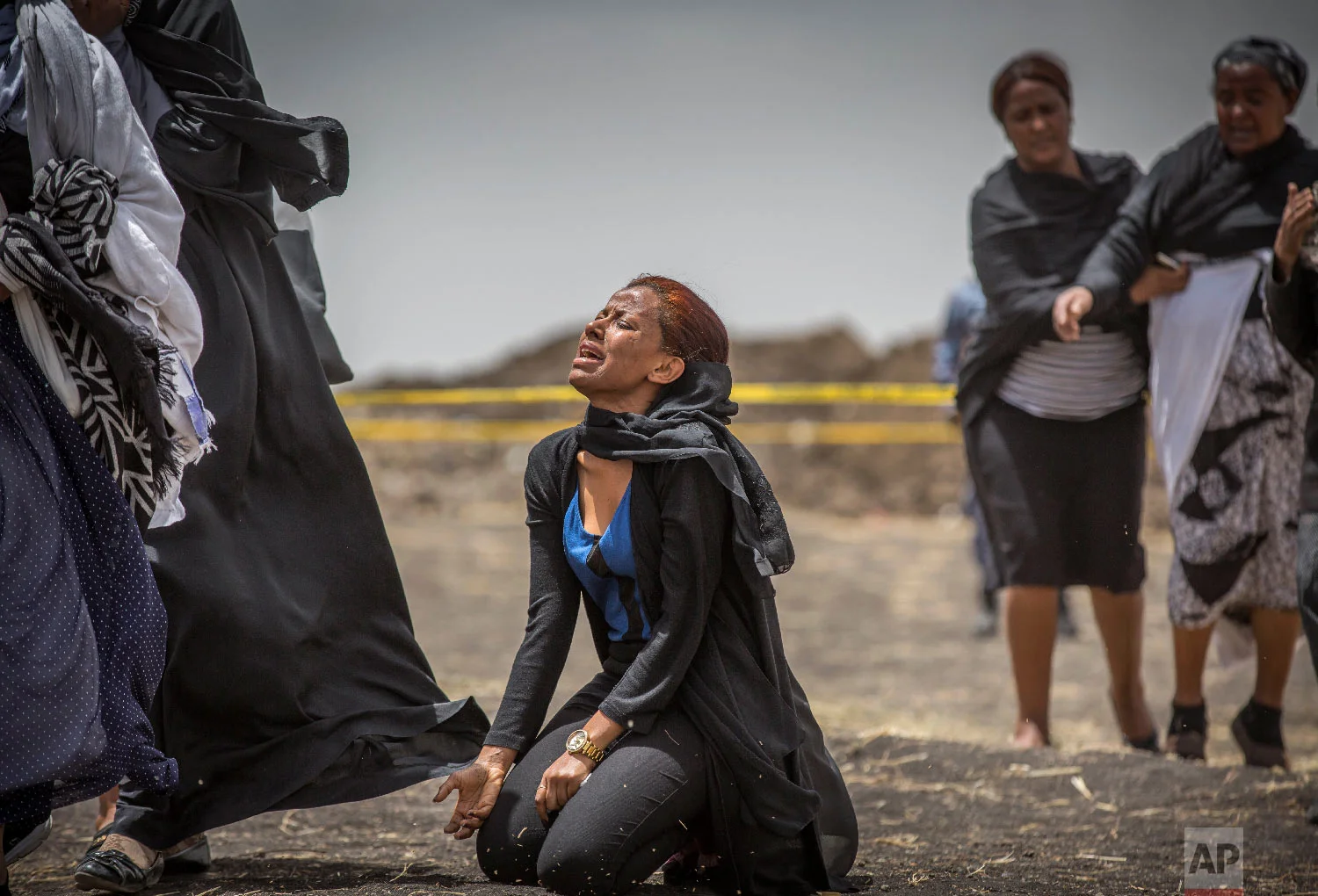 Ethiopian relatives of crash victims mourn and grieve at the scene where the Ethiopian Airlines Boeing 737 Max 8 crashed shortly after takeoff on Sunday near Bishoftu, Ethiopia, March 14, 2019. (AP Photo/Mulugeta Ayene)