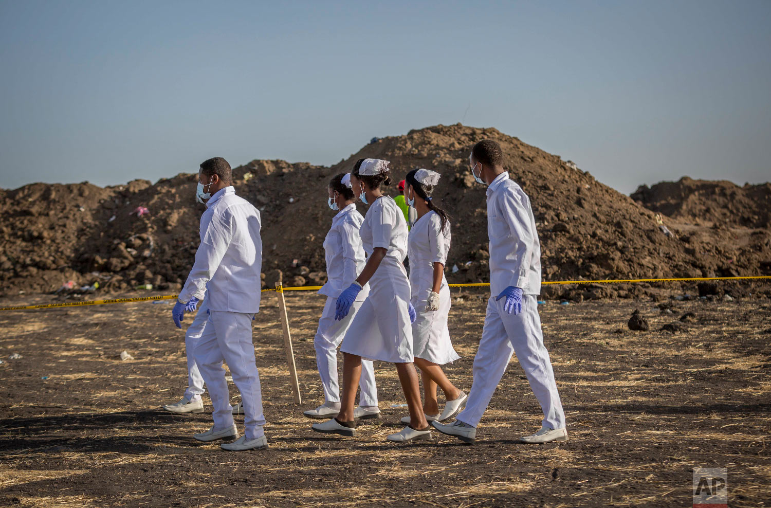 Nurses walk to collect materials, under the instruction of investigators March 12, 2019. (AP Photo/Mulugeta Ayene)