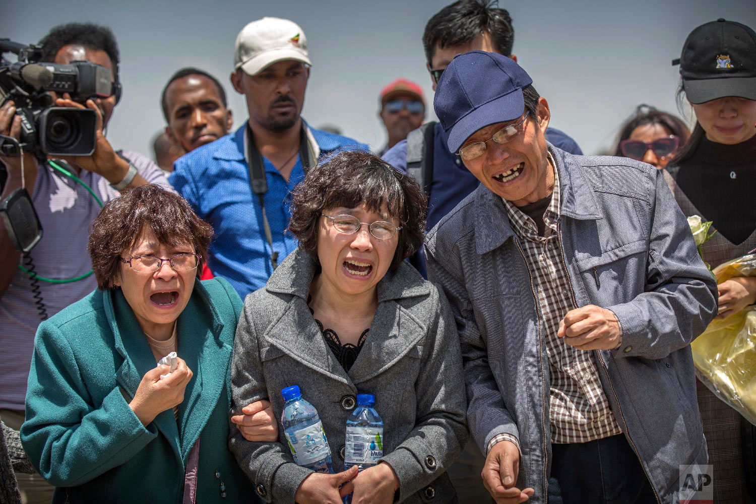 Family members cry at the scene where the Ethiopian Airlines Boeing 737 Max 8 crashed shortly after takeoff on Sunday near Bishoftu, Ethiopia, March 13, 2019. (AP Photo/Mulugeta Ayene)