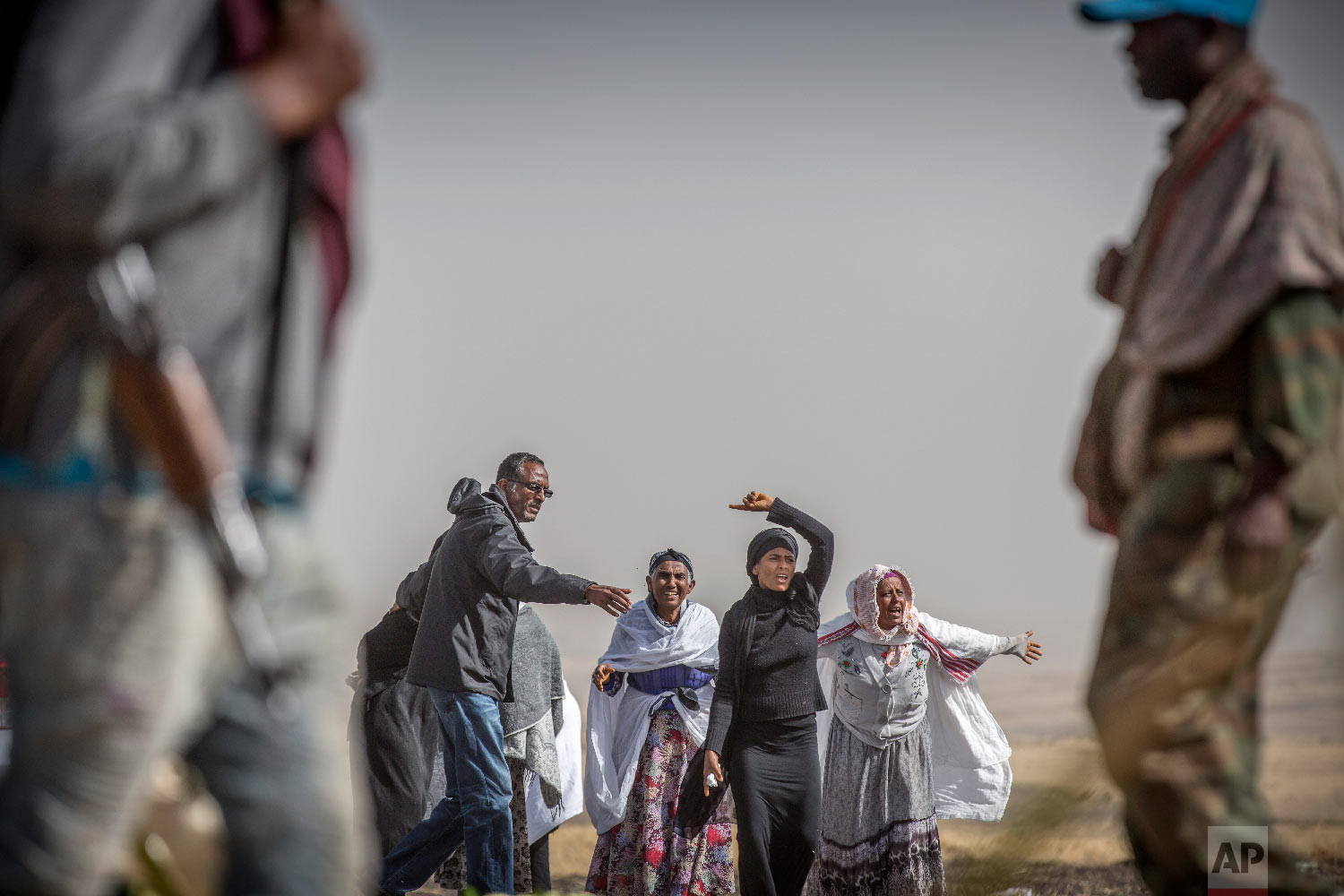 Ethiopian relatives of crash victims mourn at the scene where the Ethiopian Airlines Boeing 737 Max 8 crashed shortly after takeoff on Sunday near Bishoftu, Ethiopia, March 14, 2019. (AP Photo/Mulugeta Ayene)