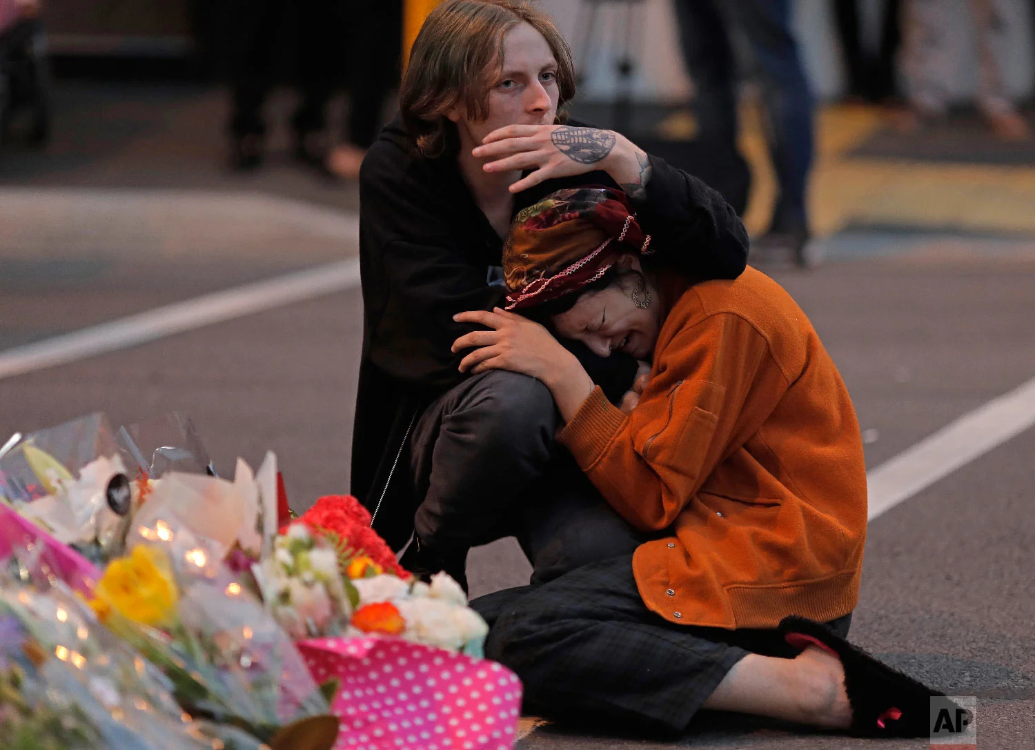 Mourners pay their respects at a makeshift memorial near the Masjid Al Noor mosque in Christchurch, New Zealand, Saturday, March 16, 2019. (AP Photo/Vincent Yu)