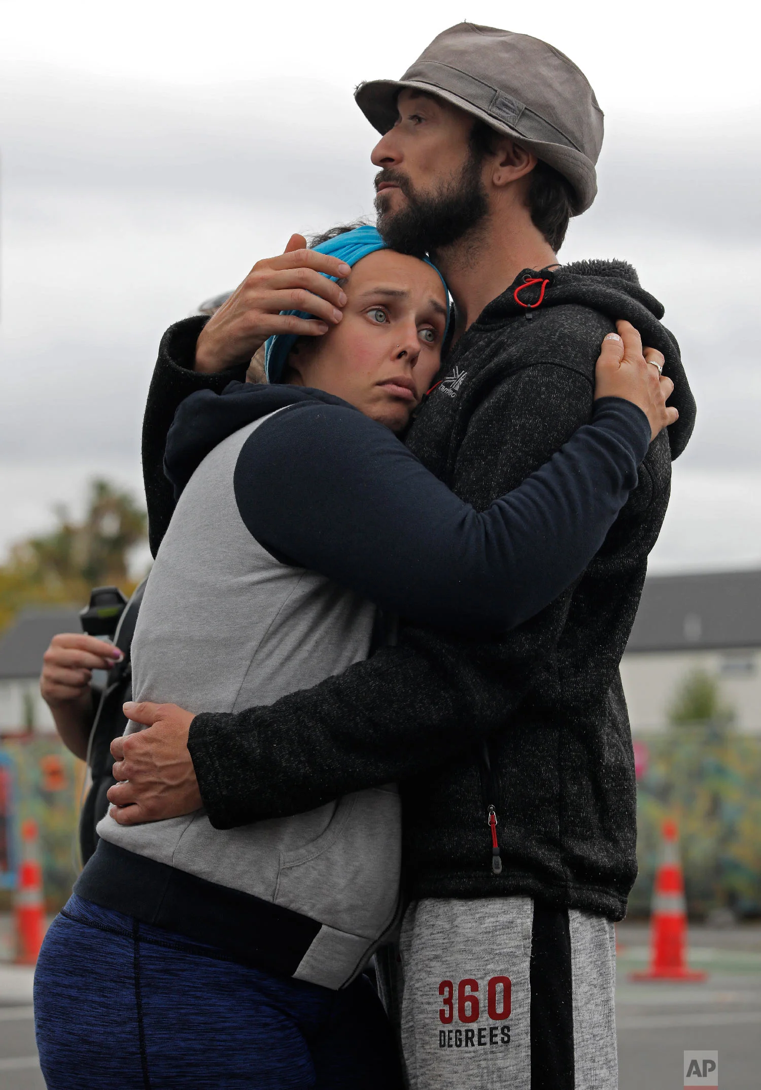 Mourners hug as they pay their respects at a memorial near the Masjid Al Noor mosque in Christchurch, New Zealand, Saturday, March 16, 2019, near where one of the two mass shootings occurred Friday. (AP Photo/Vincent Yu)