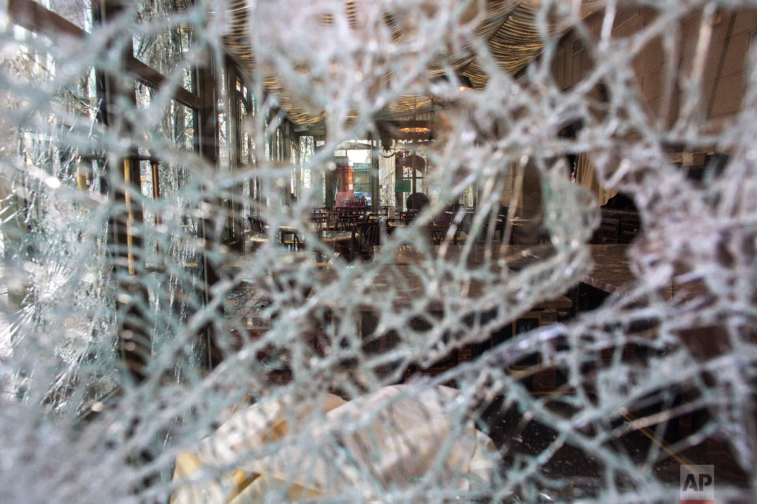The inside view of the famed tea salon Laduree pictured through smashed windows the day after it was vandalized during the 18th straight weekend of demonstrations by the yellow vests, in Paris, March 17, 2019. (AP Photo/Rafael Yaghobzadeh)