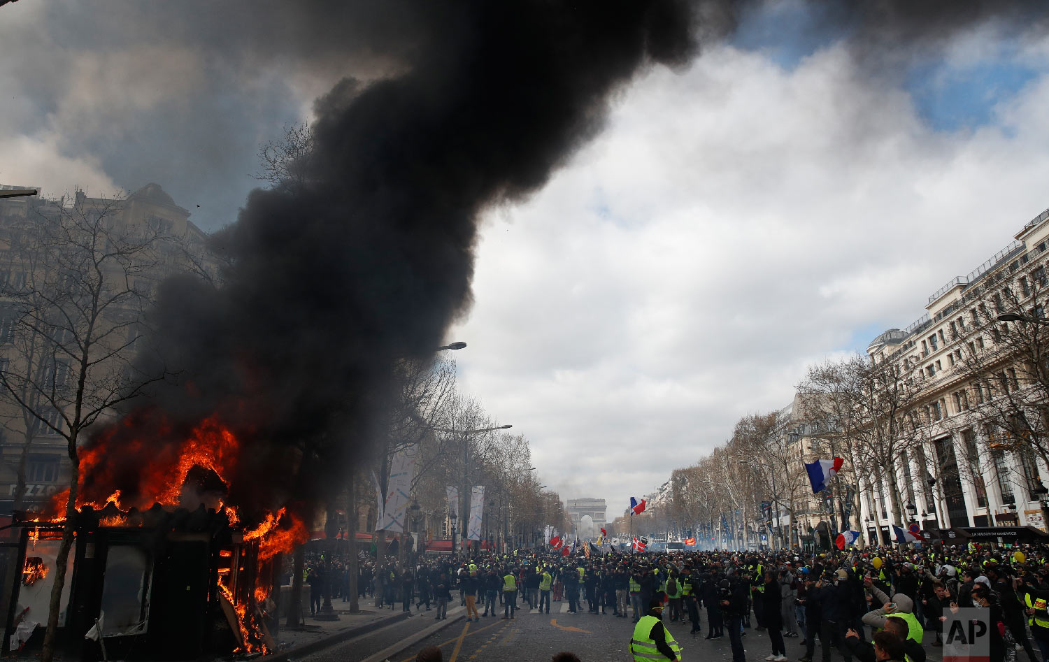 A news stand burns during a yellow vests demonstration on the Champs Elysees avenue March 16, 2019, in Paris. (AP Photo/Christophe Ena)