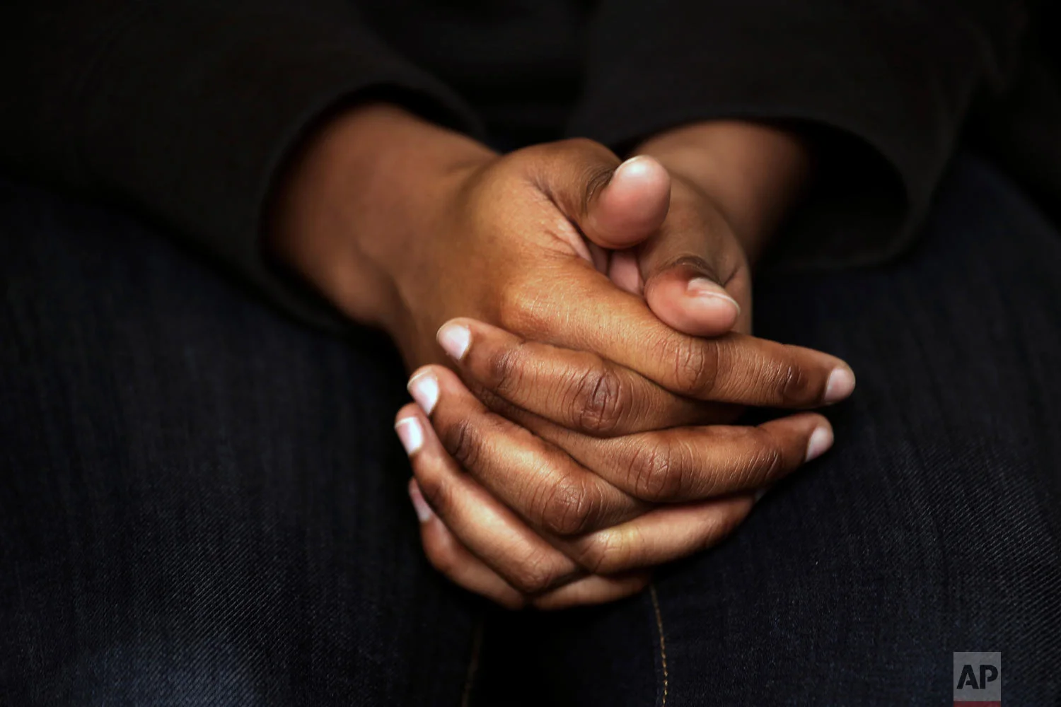A survivor of sexual assault holds her hands as she speaks during an interview in the Brooklyn borough of New York on Wednesday, March 6, 2019. (AP Photo/Wong Maye-E)