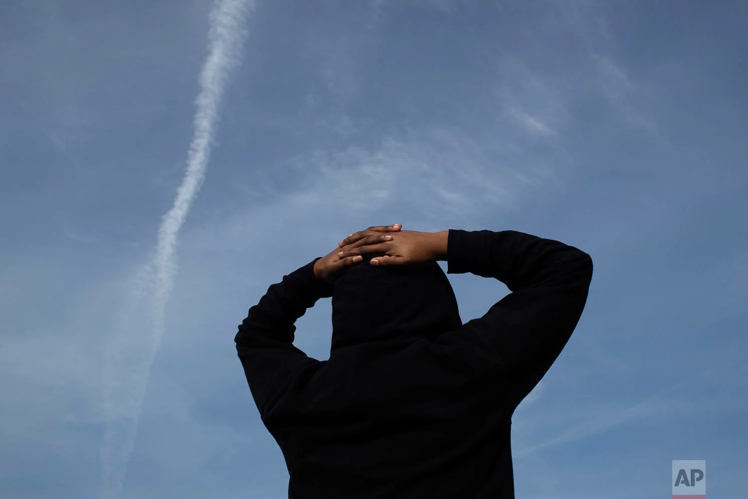A survivor of sexual assault looks at the evening sky in the Brooklyn borough of New York on Thursday, March 14, 2019. The young woman seeks peace through meditation. She said that she was assaulted by someone she knew but never reported it because she feared she wouldn’t be believed. (AP Photo/Wong Maye-E)