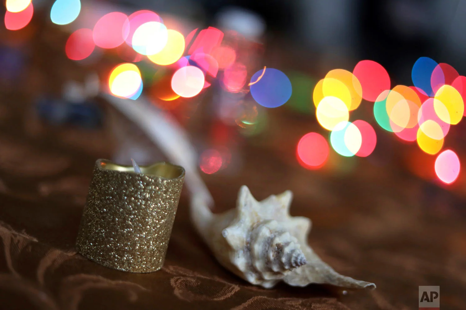 A candle and a shell are displayed during a meeting for the "Sisters in Strength" in the Brooklyn borough of New York on March 14, 2019. (AP Photo/Wong Maye-E)