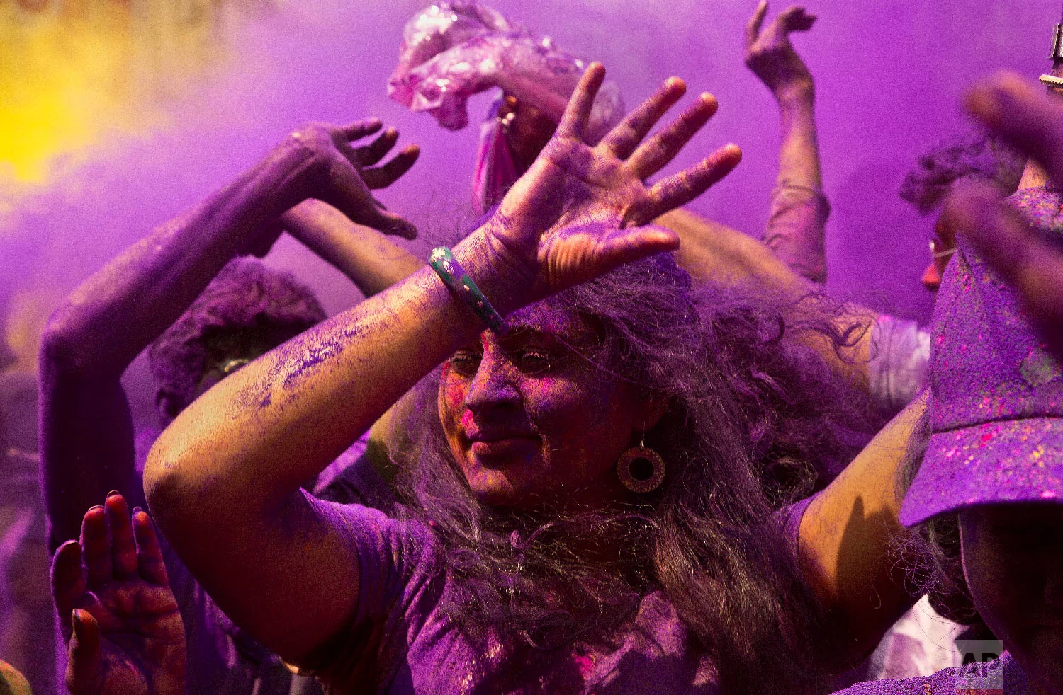Indians dance during celebrations marking Holi, the festival of colors, in Gauhati, India, Thursday, March 21, 2019. (AP Photo/Anupam Nath)