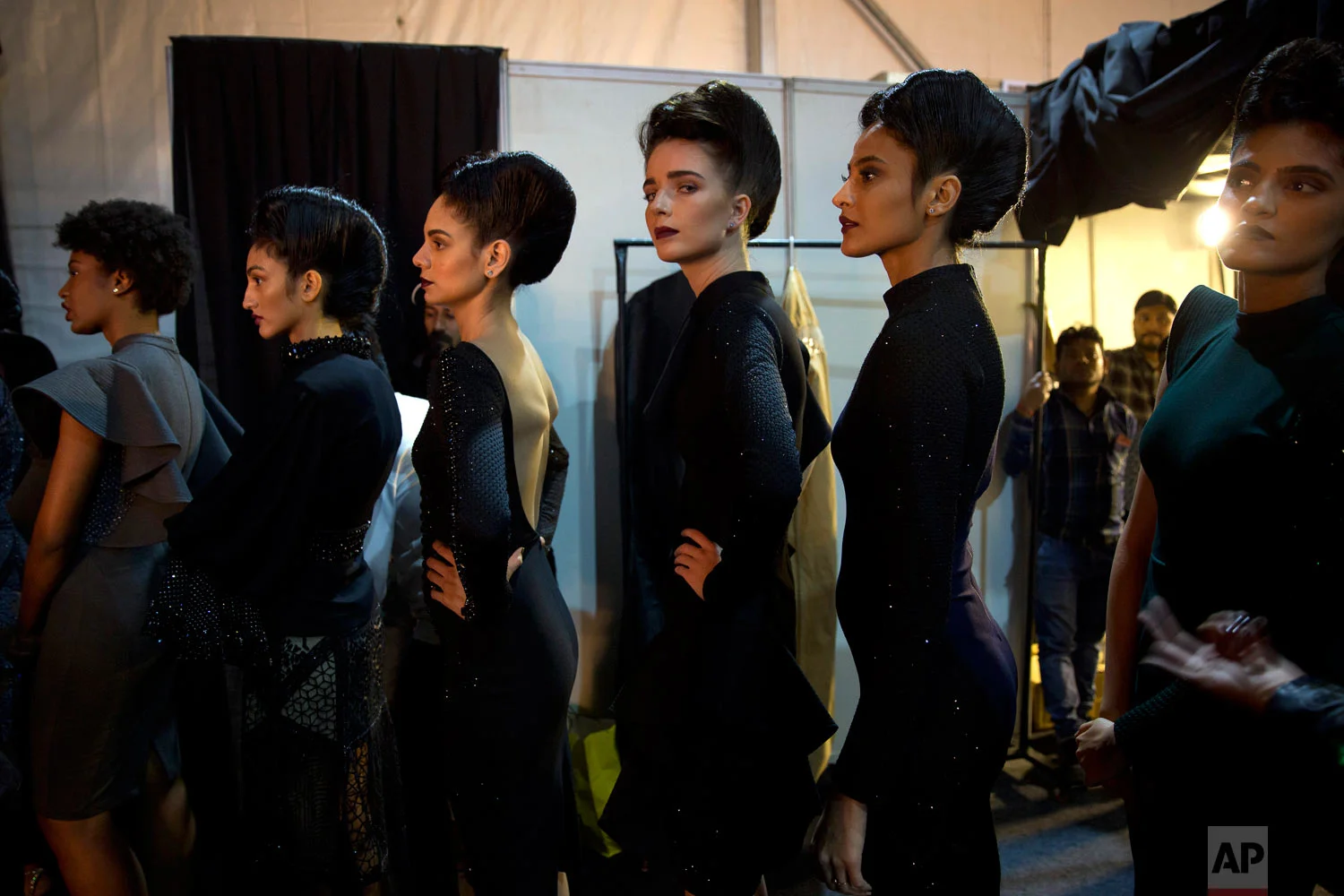 Models line up backstage before the start of a catwalk during the Lotus Makeup India Fashion Week, Saturday, March 16, 2019, in New Delhi, India. (AP Photo/Manish Swarup)