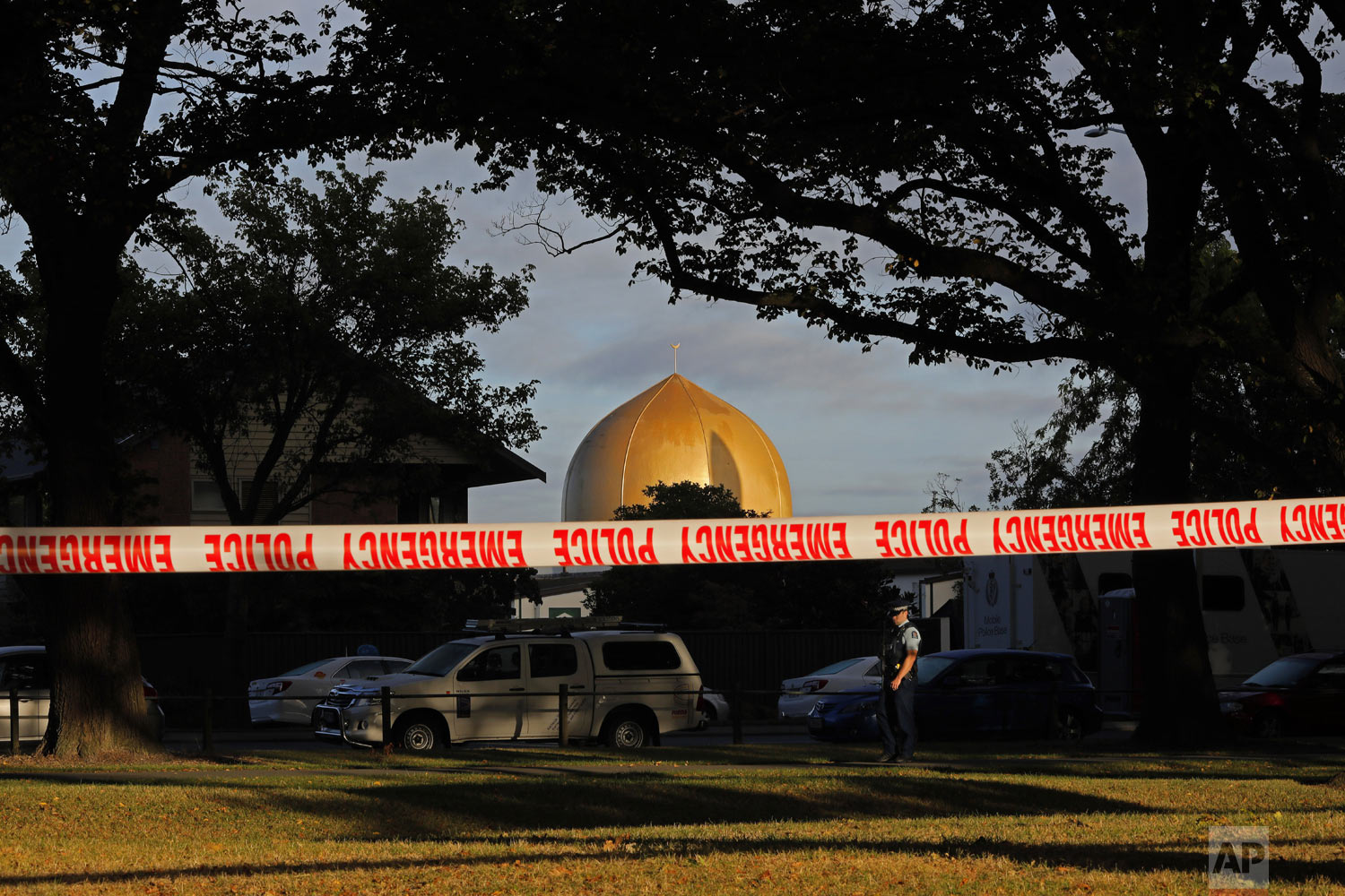 A police officer stands guard in front of the Masjid Al Noor mosque in Christchurch, New Zealand, Sunday, March 17, 2019, where one of two mass shootings occurred. (AP Photo/Vincent Yu)
