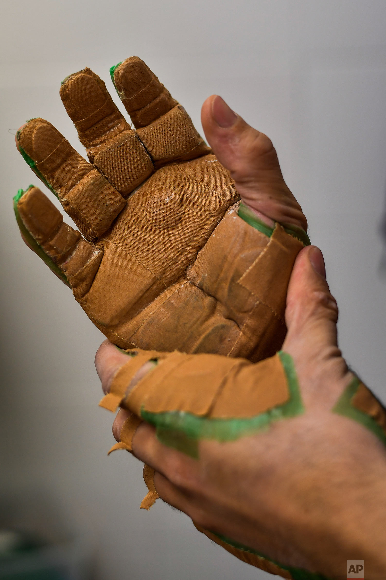 Victor Esteban, a player of Basque Ball, known as "pelotari", prepares and protects his hands ahead of a training session, in Pamplona, Spain on Feb. 28, 2019. (AP Photo/Alvaro Barrientos)