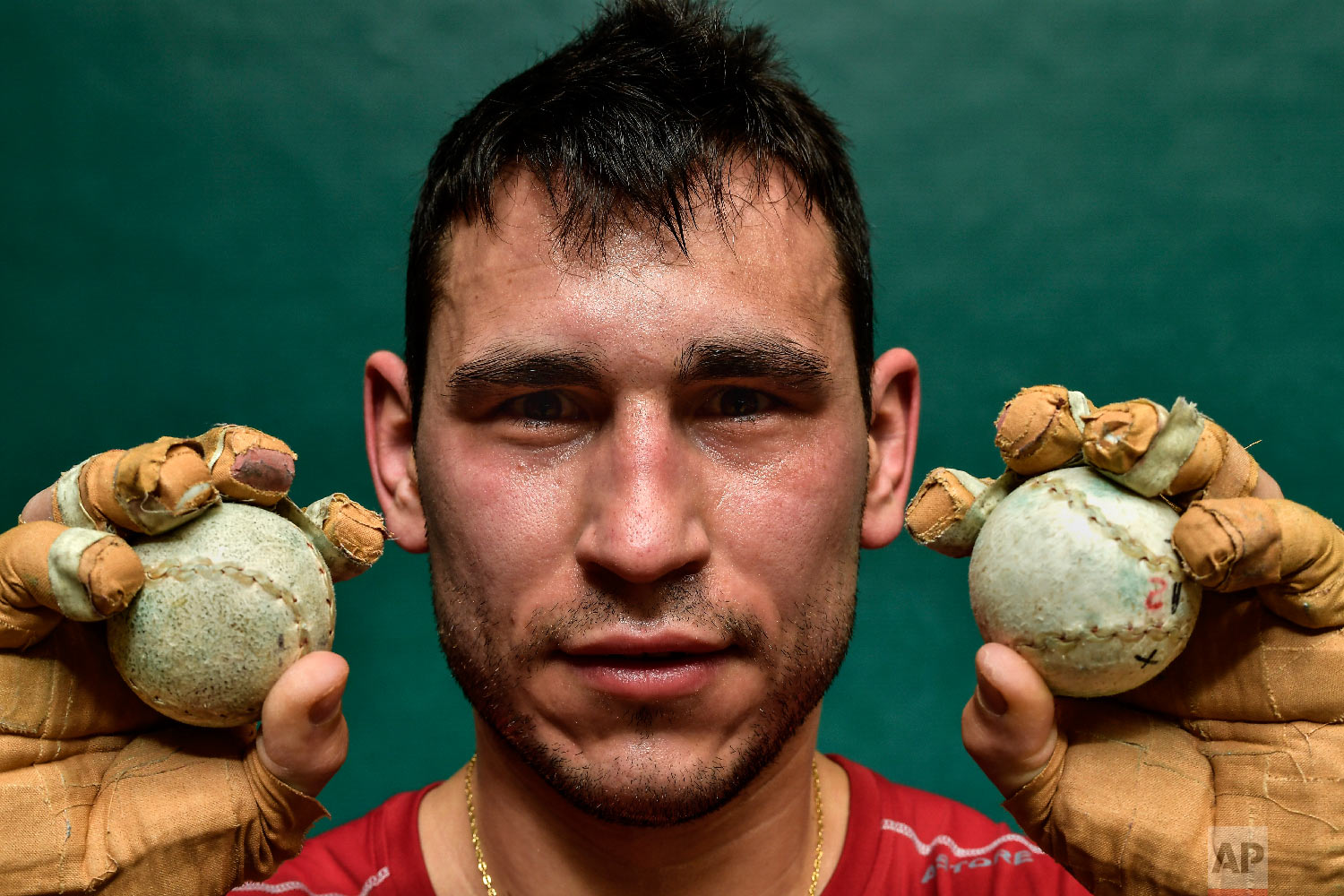Diego Iturriaga, 27, a player of Basque Ball known as "pelotari", holds Basque Balls as he poses for a photo at Labrit court or fronton, in Pamplona, northern Spain on March 5, 2019. (AP Photo/Alvaro Barrientos)