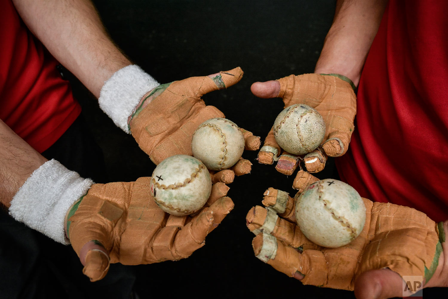 Players of Basque Ball hold balls on their hands protected by layers of tightly-bound tape, in Pamplona, northern Spain on March 5, 2019. (AP Photo/Alvaro Barrientos)