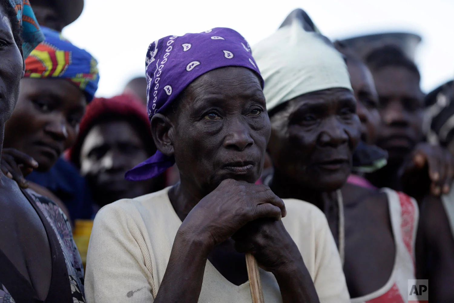 An elderly woman stands in a queue to receive food from World Food Programme in Nhamatanda, about 100km west of Beira, Mozambique, Thursday, March 21, 2019. (AP Photo/Themba Hadebe)