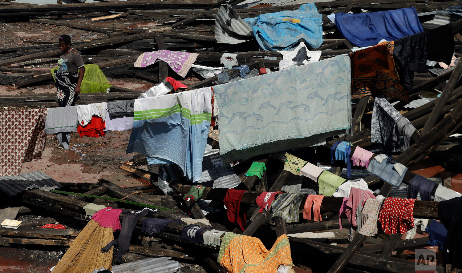 A woman hangs a her wet clothes at a displacement center in Beira, Mozambique, Friday, March 22, 2019. (AP Photo/Themba Hadebe)