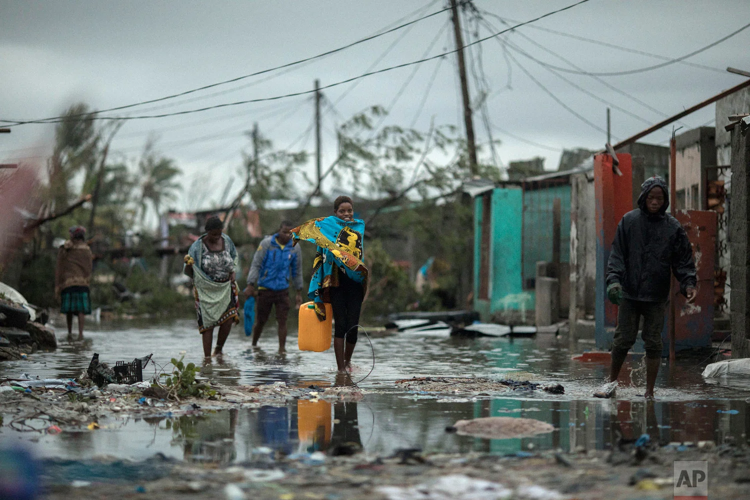 People return to Praia Nova Village, one of the most affected neighborhoods following a cyclone in the coastal city of Beira, Mozambique, Sunday March 17, 2019. (Josh Estey/CARE via AP)