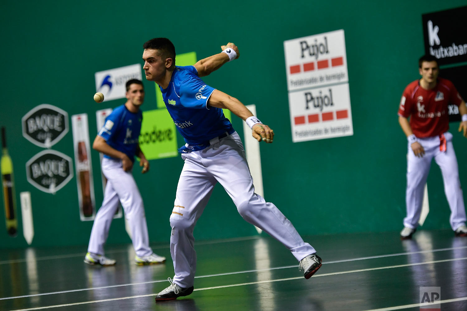 Basque Ball player or "pelotari" Victor Esteban, returns the ball during a match at Labrit court or fronton, in Pamplona, northern Spain on March 9, 2019. (AP Photo/Alvaro Barrientos)