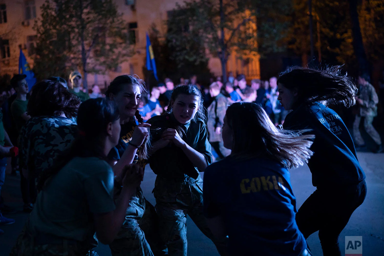 Members of the nationalist group Sokil, the youth wing of the Svoboda party, bump into each other during a concert in Kiev, Ukraine, April 21, 2018. (AP Photo/Felipe Dana)