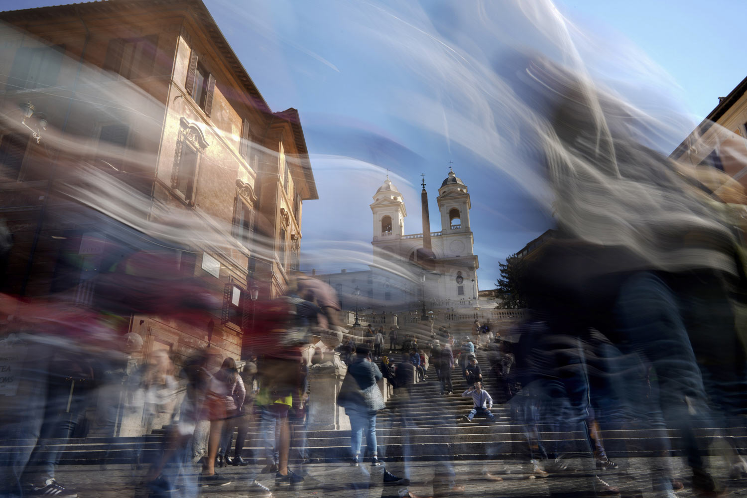 In this photo made with a long exposure, people walk by the Spanish Steps in Rome, Monday, March 25, 2019. (AP Photo/Andrew Medichini)