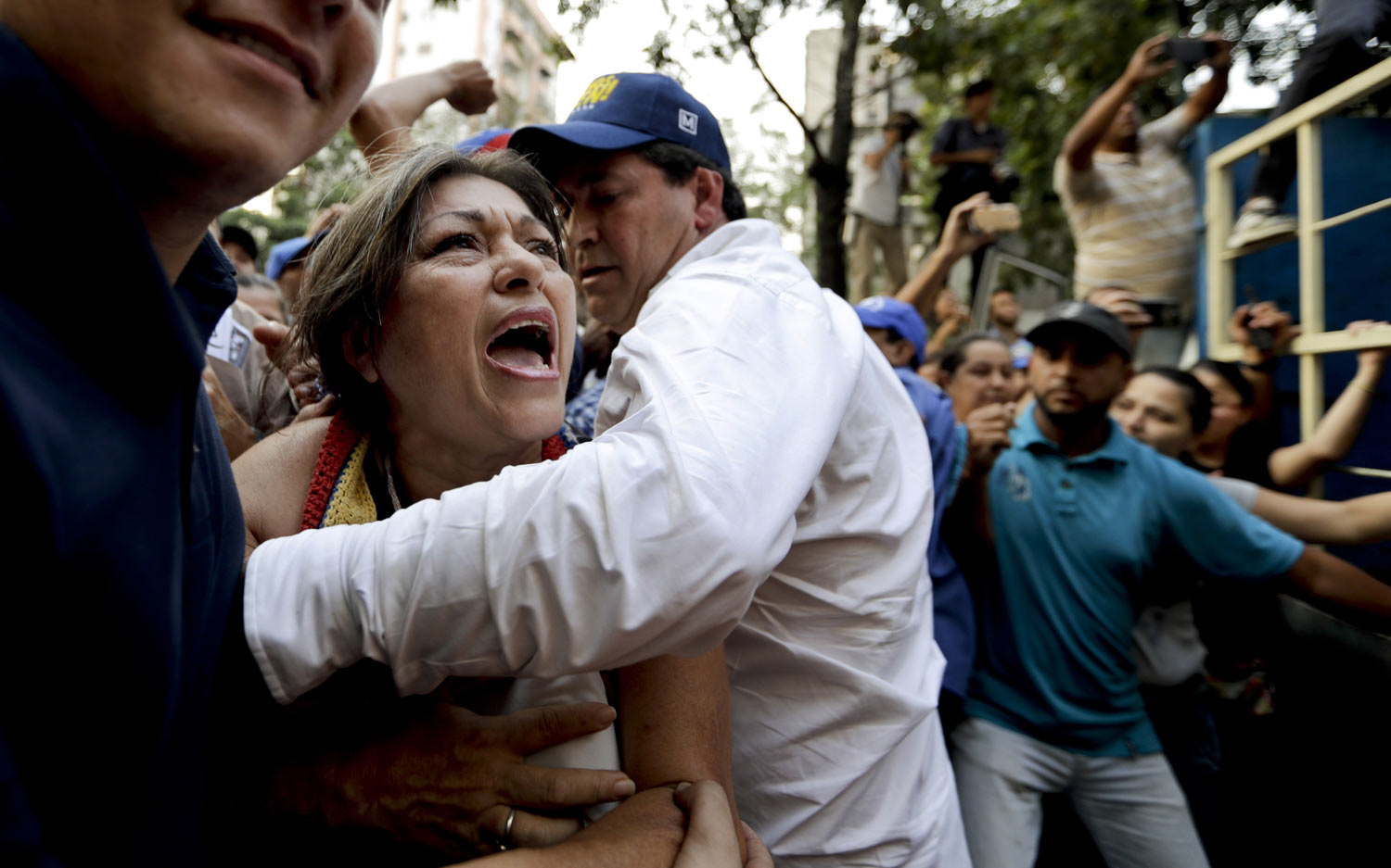  A supporter of Venezuela's self-proclaimed interim president Juan Guaido is stopped as she tries to approach him during a rally in Caracas, Venezuela, on Thursday, March 28, 2019. On Thursday, the Venezuelan government said it has barred Guaido from