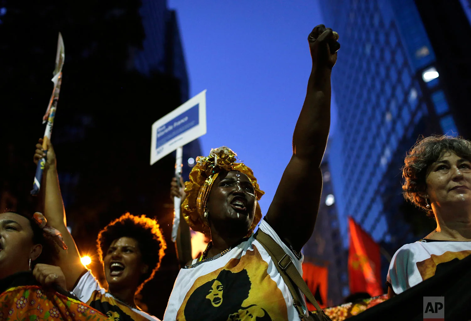 In this March 8, 2019 photo, women shout slogans during a march marking International Women's Day in Rio de Janeiro, Brazil. (AP Photo/Silvia Izquierdo)