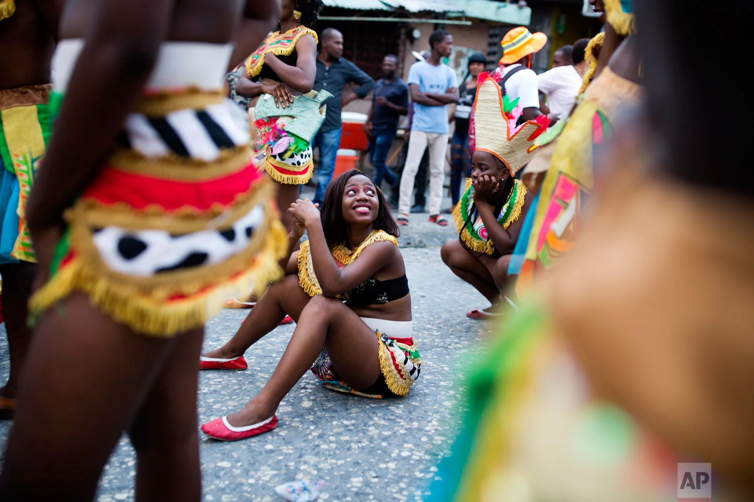 In this March 5, 2019 photo, revelers rest in the street during the Carnival parade in the Carrefour district of Port-au-Prince, Haiti. ( AP Photo/Dieu Nalio Chery)