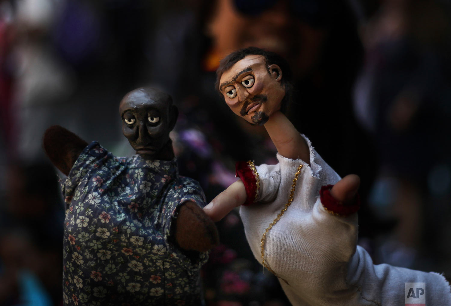 In this March 24, 2019 photo, a puppeteer presents his hand puppets during an event at the National Culture Museum in Mexico City. The event was held in honor of World Puppetry Day, observed earlier in the week on March 21. (AP Photo/Marco Ugarte)